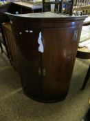 18TH CENTURY MAHOGANY BOW FRONTED WALL HANGING CORNER CUPBOARD WITH TWO CUPBOARD DOORS AND BRASS