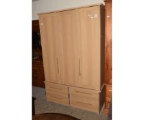 MODERN BEECHWOOD EFFECT TRIPLE DOOR WARDROBE WITH FOUR DRAWERS TO BASE WITH WOODEN OBLONG HANDLES