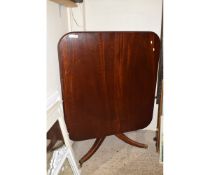 GEORGIAN MAHOGANY SQUARE TILT TOP TABLE WITH A SPLAYED TRIPOD BASE AND BRASS CAPPED CASTERS