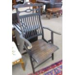 Dark stained slat back folding campaign chair