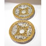 Pair of circular pierced gilded and silvered cast metal plaques depicting mythological figures, 22cm