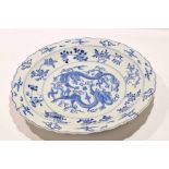 Large Chinese porcelain charger with scalloped rim, decorated in Kiangxi style with sinuous