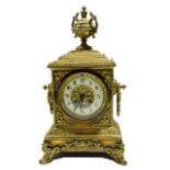 Victorian brass mantel clock crested with an urn over an Arabic chapter ring, 21cm wide