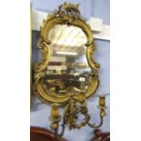 19th century gilt and gesso girandole with C-scroll frame and applied below with three candle
