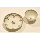 18th century English Porcelain Lowestoft tea bowl and saucer of fluted shape with a floral design,