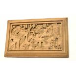 Carved wooden Oriental panel with figures in a rickshaw and other figures in various pursuits,