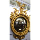 Regency style gilded convex circular wall mirror crested with an eagle, 100cm high