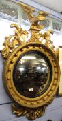 Regency style gilded convex circular wall mirror crested with an eagle, 100cm high