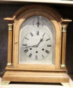 Early 20th century oak cased bracket clock, silvered arched face by Neill of Belfast, with chime/