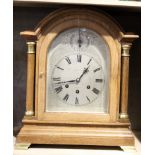 Early 20th century oak cased bracket clock, silvered arched face by Neill of Belfast, with chime/