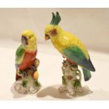 Pair of Continental porcelain parrots, highly coloured on branches, with four splayed feet,