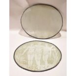 Two large glass oval panels with lead rims, decorated with three African figures amongst flowers, by