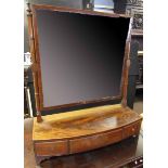 Early 19th century mahogany toilet mirror, bowed base with three drawers on bracket feet, 69cm wide