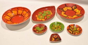 Group of high fired Poole Pottery studio wares, the red ground with geometric designs including an