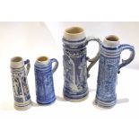 Group of four German stoneware steins or tankards with typical designs, largest with scroll