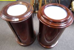 Matched pair of Victorian style mahogany cylindrical pot cupboards with single doors, marble
