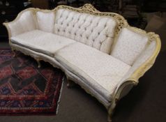 French style cream damask upholstered large four-seater settee with serpentine front and pierced and