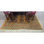 Small Afghan wool carpet with black geometric and medallion designs to an orange ground, 278cm x