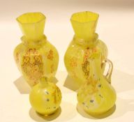 Group of coloured yellow glass with gilt decoration including two vases, two small ewers