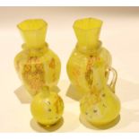 Group of coloured yellow glass with gilt decoration including two vases, two small ewers