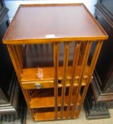Mahogany revolving bookcase fitted with sections and drawers, 183cm high