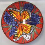 Poole Pottery charger with butterfly design on red ground, the base with factory mark, limited