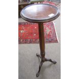 Mahogany torchere stand, circular top with moulded edge raised on octagonal and fluted support