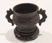 Chinese bronze censer on wooden stand with two dragon handles and typical relief decoration, 10cm