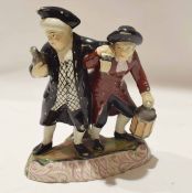 Late 19th century Staffordshire group of revellers on an oval base, 23cm high