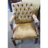 Mahogany framed and faded tan leather upholstered button back armchair with brass studded detail (