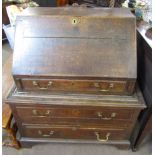Oak bureau, fall front over a fitted interior with three drawers below, 18th century and later,