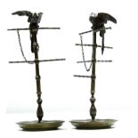 Pair of bronze or cast metal ring stands, each crested with perched birds, 22cm high
