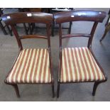 Set of four late Regency mahogany curved bar back dining chairs on sabre legs, with drop in