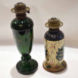 Zsolnay style pottery oil lamp (hairline crack) and a further green glass oil lamp (traces of