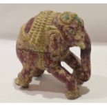 An unusual Tang style model of an elephant carved in wood with traces of original colouring, 16cm