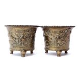 Two Oriental brass jardinieres decorated with dragons, on three stub feet with reign mark to base,