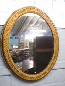 Gilt framed oval wall mirror with beaded and latticed surround, 70cm wide