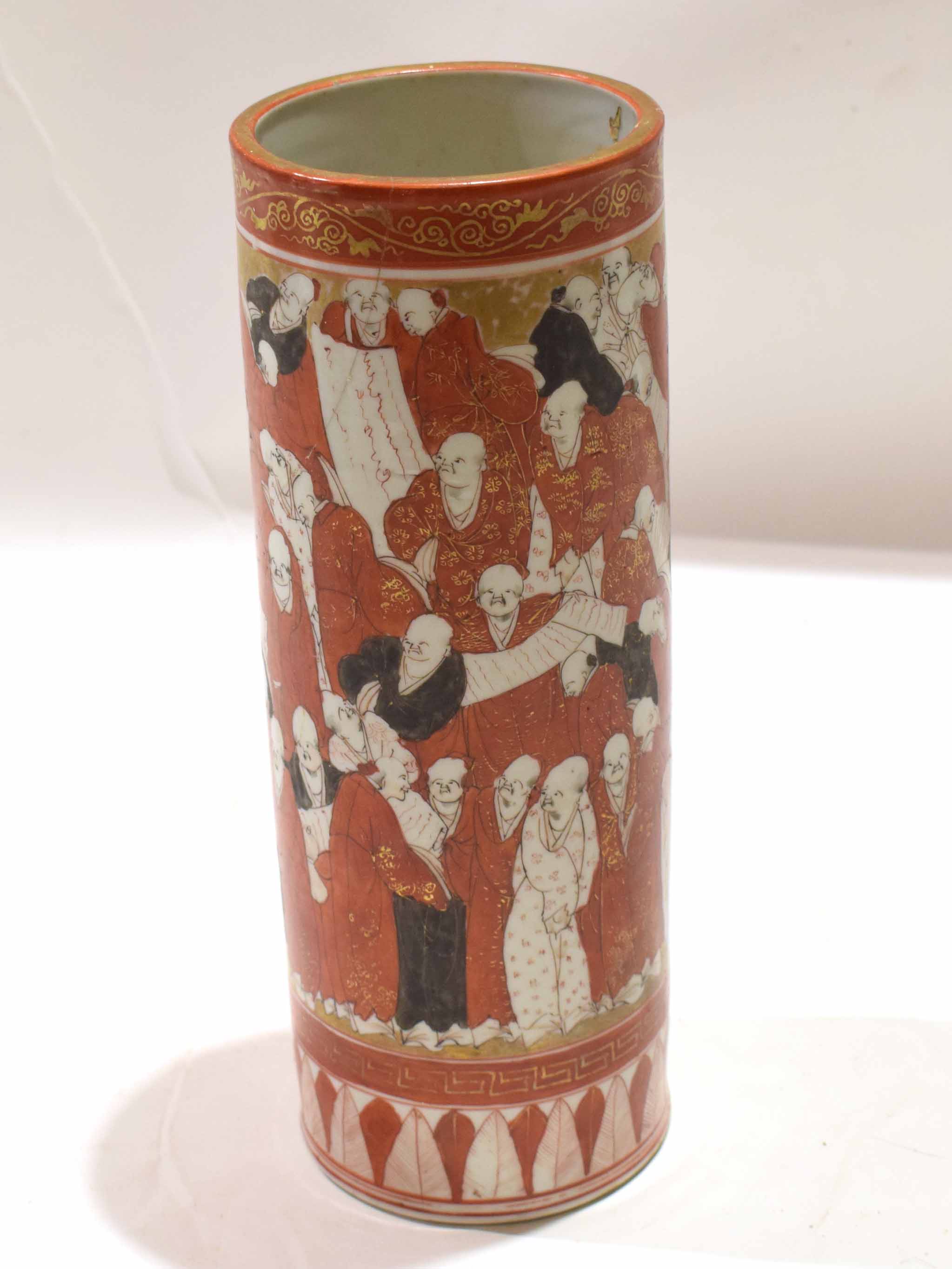 Japanese Kutani style porcelain cylindrical vase, decorated with figures in red, black and gilt on a