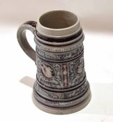 German stoneware 1ltr ale jug or tankard decorated in relief in manganese with typical applied