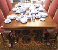 Early 20th century mahogany extending dining table (wind-out type), supported on four carved bold