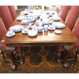 Early 20th century mahogany extending dining table (wind-out type), supported on four carved bold