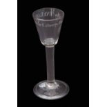 Mid-18th century important political wine glass, the rounded funnel bowl above a plain stem and