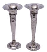 Tall pair of George V trumpet flower vases on plain circular loaded bases with spot hammered