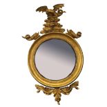 Regency period gilt framed circular convex wall mirror crested with a dragon and fish and applied