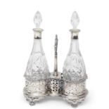 Victorian silver plated double bottle stand of waisted oval form, the raised holders pierced with
