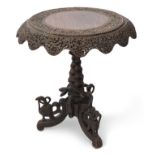Anglo-Indian hardwood pedestal table, circular top with a swept shaped frieze raised on central