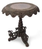 Anglo-Indian hardwood pedestal table, circular top with a swept shaped frieze raised on central