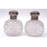 Pair of late Victorian hobnail cut oval glass scent bottles, the hinged lids and collars heavily