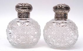 Pair of late Victorian hobnail cut oval glass scent bottles, the hinged lids and collars heavily