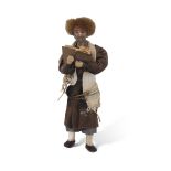 Middle Eastern or Afghan doll modelled as a man wearing prayer shawl reading the Koran, 20cm long